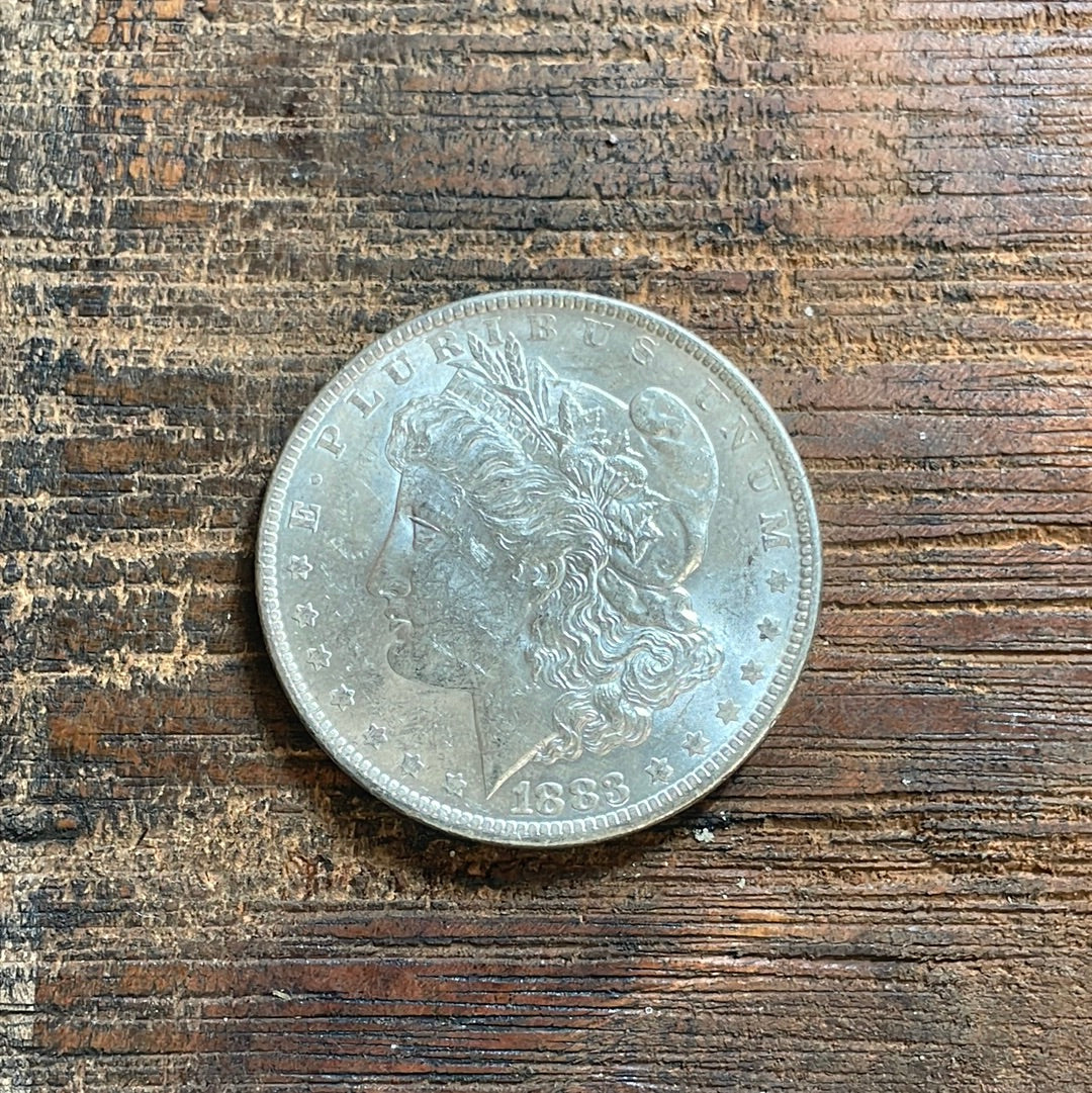 1883-O $1 US Morgan Silver Dollar.