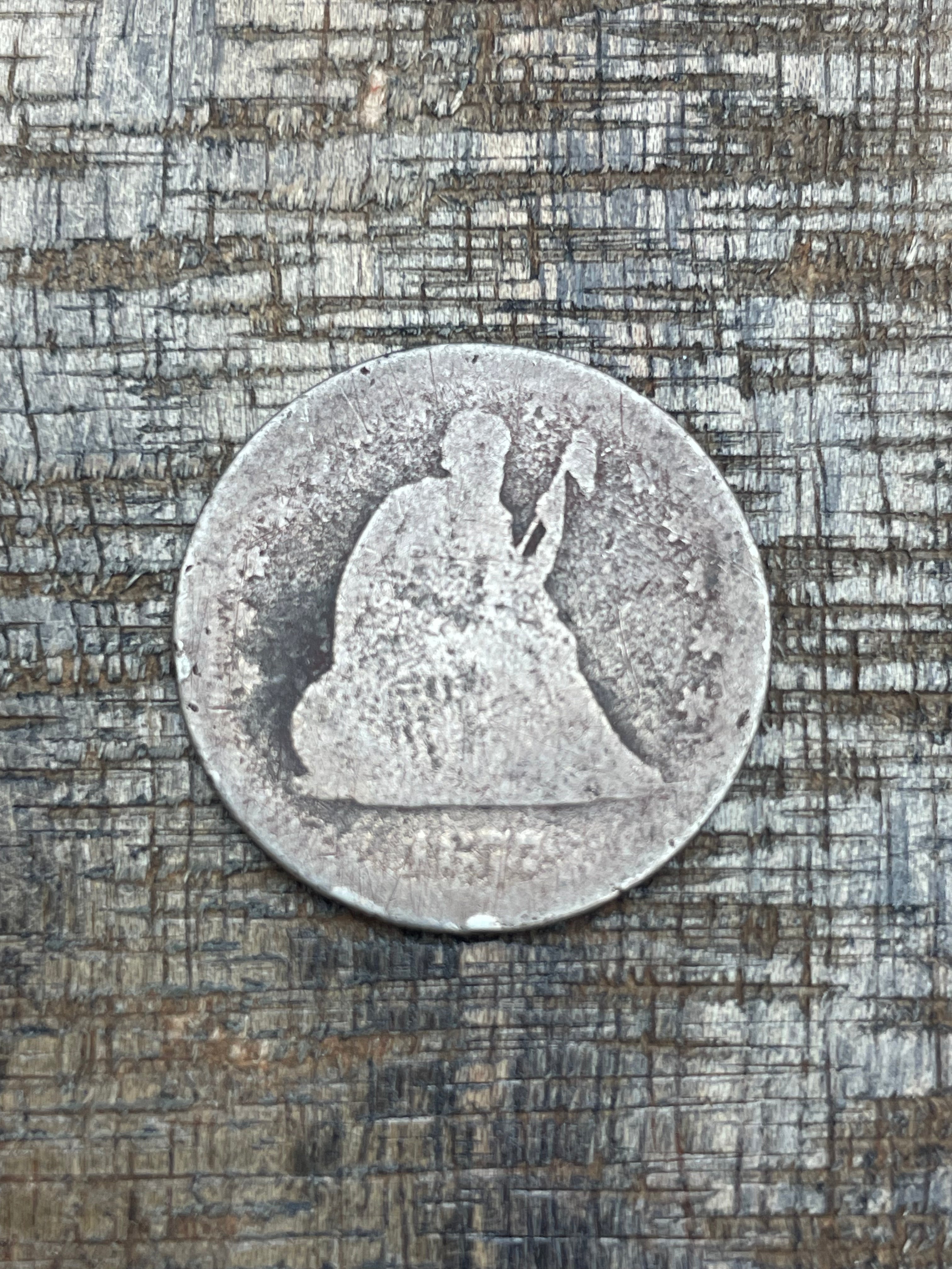 1877 25c US Seated Liberty Quarter ~ Poor condition unable to see a mint mark